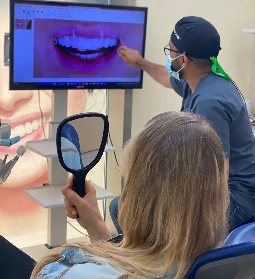 Dr. Maroof Beg reviewing a digital smile scan with a patient